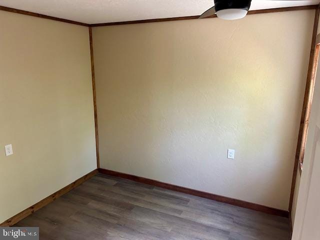 unfurnished room featuring crown molding, hardwood / wood-style floors, and ceiling fan