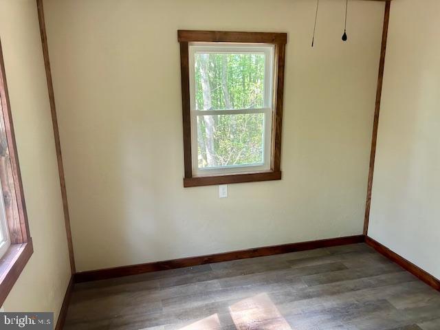 unfurnished room with dark hardwood / wood-style floors