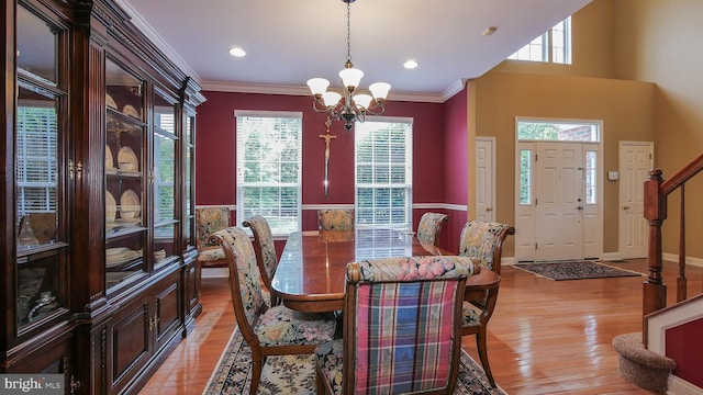 dining room featuring ornamental molding, a notable chandelier, and light wood-type flooring