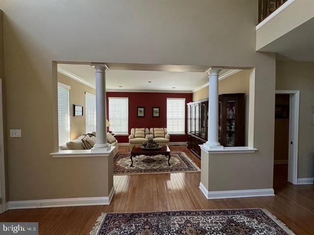 living room with hardwood / wood-style floors and crown molding