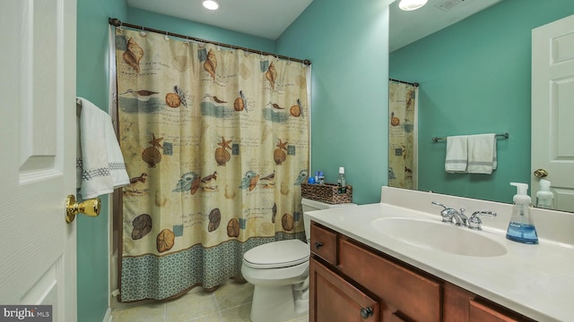 bathroom with tile patterned floors, vanity, and toilet