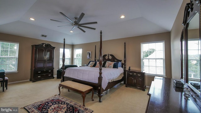 carpeted bedroom featuring ceiling fan, a raised ceiling, and vaulted ceiling