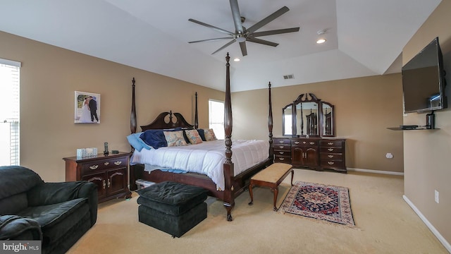 carpeted bedroom with multiple windows, ceiling fan, and lofted ceiling