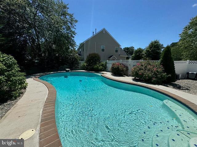 view of swimming pool featuring a diving board