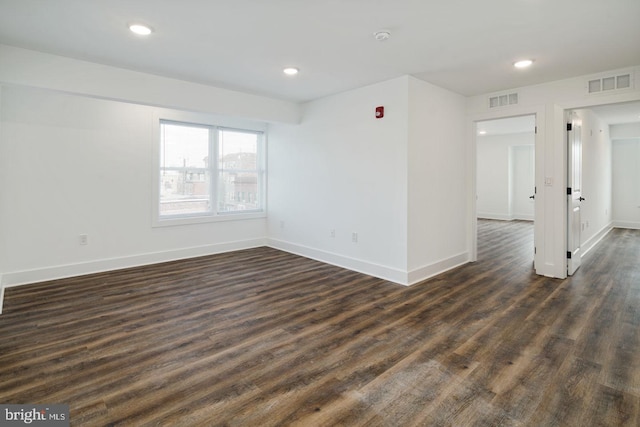 unfurnished room with dark hardwood / wood-style floors