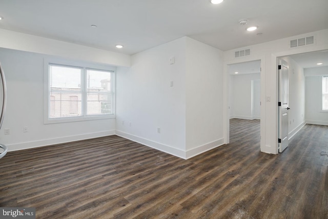 empty room with dark hardwood / wood-style flooring