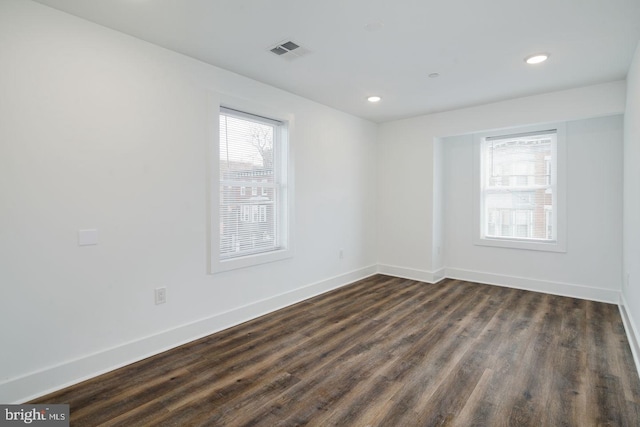 spare room with dark hardwood / wood-style floors