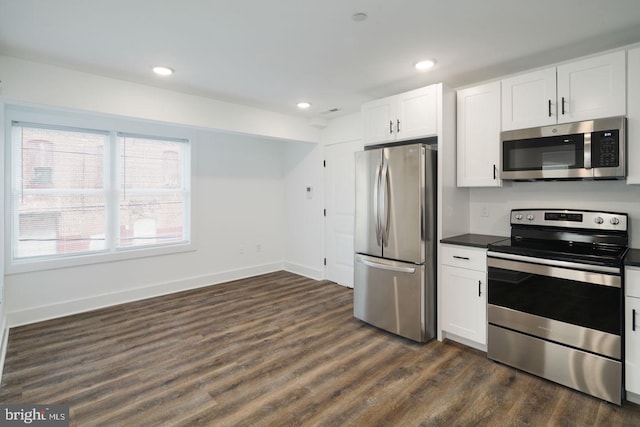 kitchen featuring white cabinetry, appliances with stainless steel finishes, and dark hardwood / wood-style floors