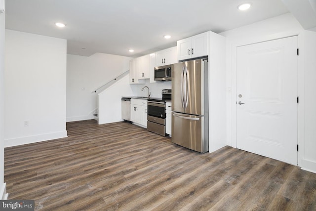 kitchen with sink, dark hardwood / wood-style flooring, white cabinetry, and appliances with stainless steel finishes