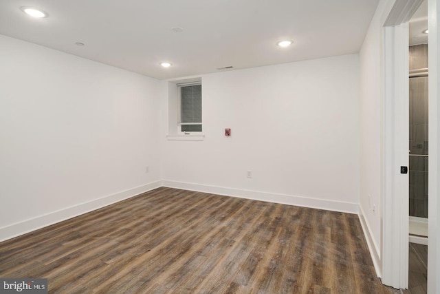 unfurnished room featuring dark wood-type flooring