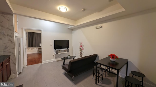 living room featuring a raised ceiling