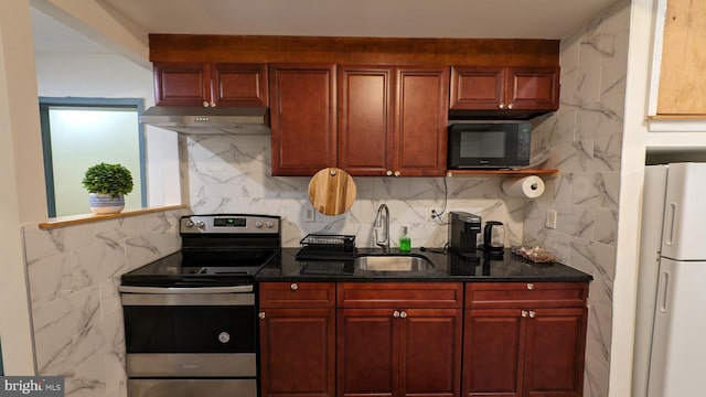 kitchen featuring backsplash, dark stone counters, stainless steel electric stove, white refrigerator, and sink