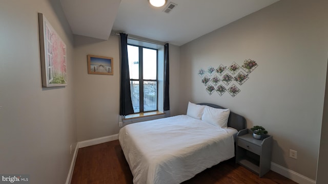 bedroom featuring dark hardwood / wood-style flooring