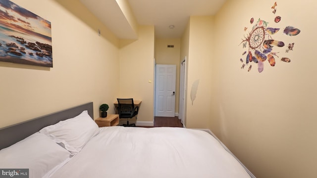 bedroom with dark wood-type flooring