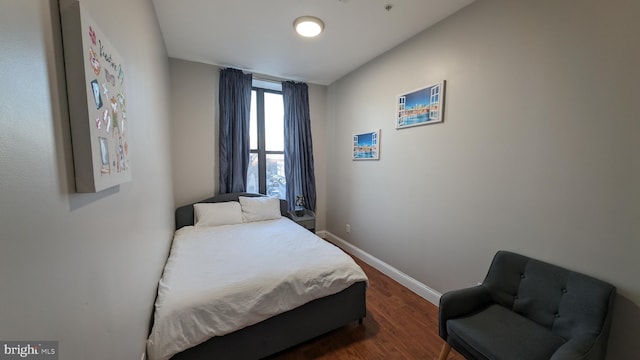 bedroom with dark hardwood / wood-style flooring