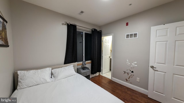 bedroom with dark wood-type flooring