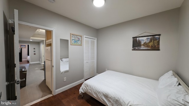 bedroom with dark hardwood / wood-style floors