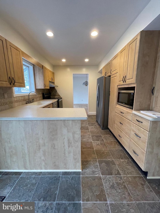 kitchen featuring kitchen peninsula, sink, light brown cabinets, and appliances with stainless steel finishes