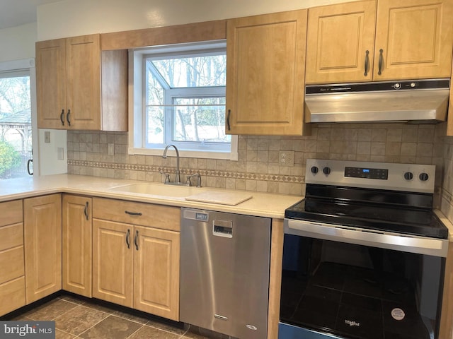 kitchen with decorative backsplash, light brown cabinets, sink, and appliances with stainless steel finishes