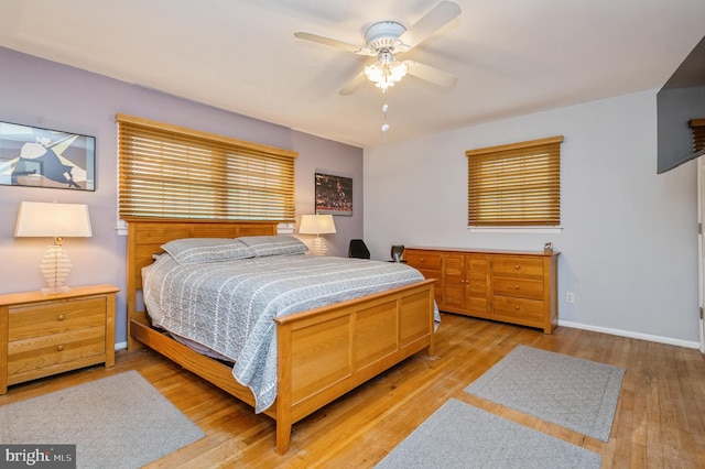 bedroom with ceiling fan and light hardwood / wood-style flooring