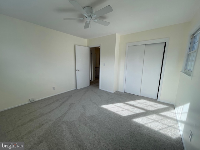 unfurnished bedroom with ceiling fan, light colored carpet, and a closet