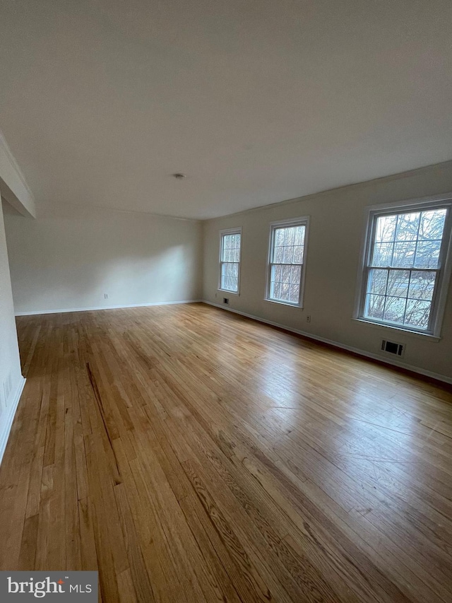 empty room with light hardwood / wood-style flooring