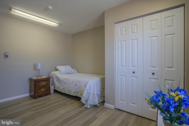 bedroom with a closet and light wood-type flooring