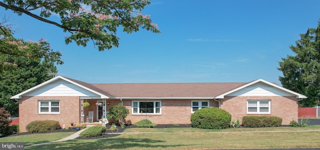 ranch-style house with a front lawn