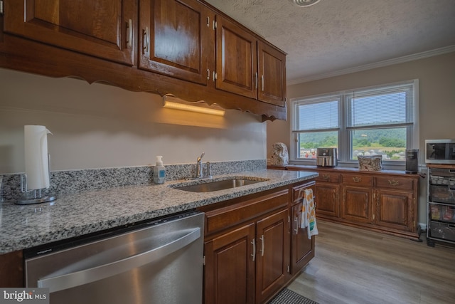 kitchen with a textured ceiling, sink, ornamental molding, and stainless steel appliances