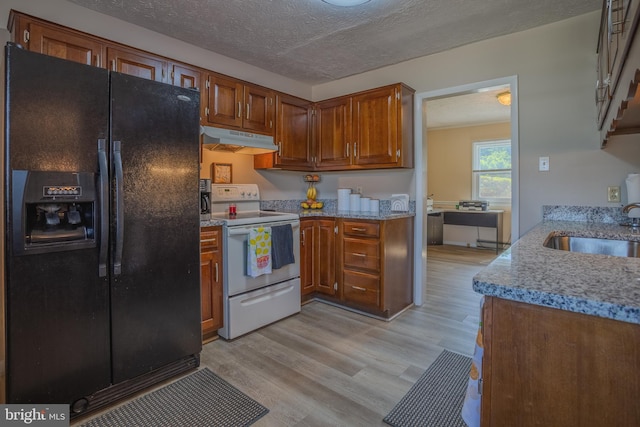 kitchen featuring sink, light hardwood / wood-style flooring, a textured ceiling, electric stove, and black fridge with ice dispenser