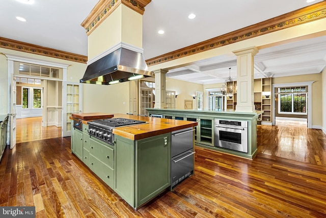 kitchen with beam ceiling, butcher block counters, stainless steel appliances, coffered ceiling, and a kitchen island