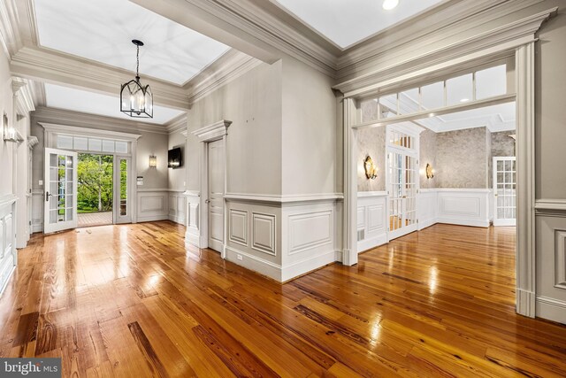 unfurnished living room with french doors and light hardwood / wood-style flooring