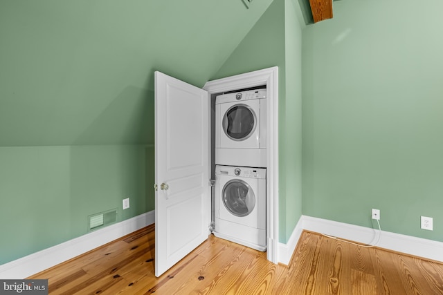 washroom featuring stacked washer / drying machine and light wood-type flooring