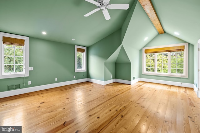 additional living space with ceiling fan, lofted ceiling with beams, and light wood-type flooring