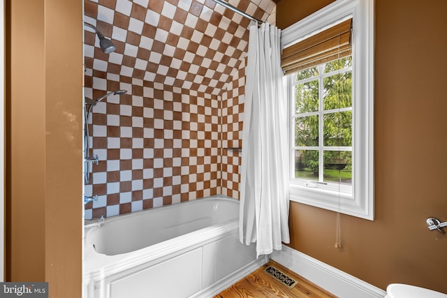 bathroom with shower / bath combination with curtain and hardwood / wood-style flooring