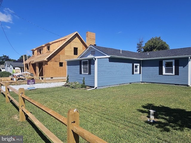 rear view of house featuring a yard