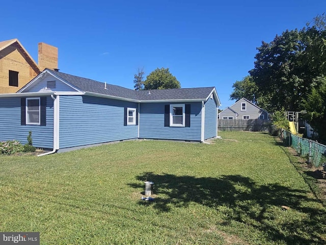 back of house with a lawn