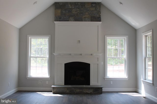 unfurnished living room with lofted ceiling, wood-type flooring, and a fireplace