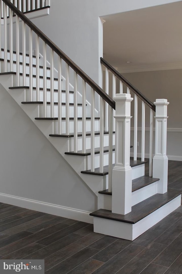 staircase featuring crown molding