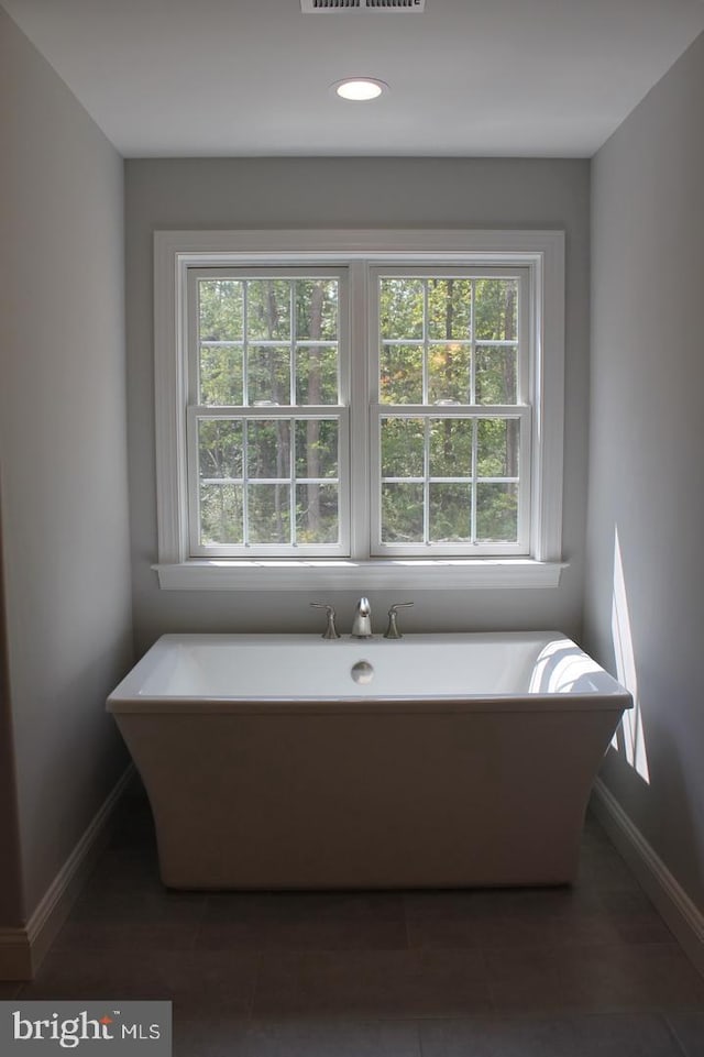 bathroom with a tub to relax in