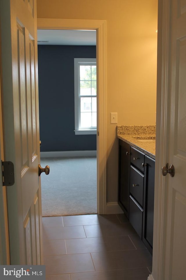 bathroom with tile patterned flooring and vanity