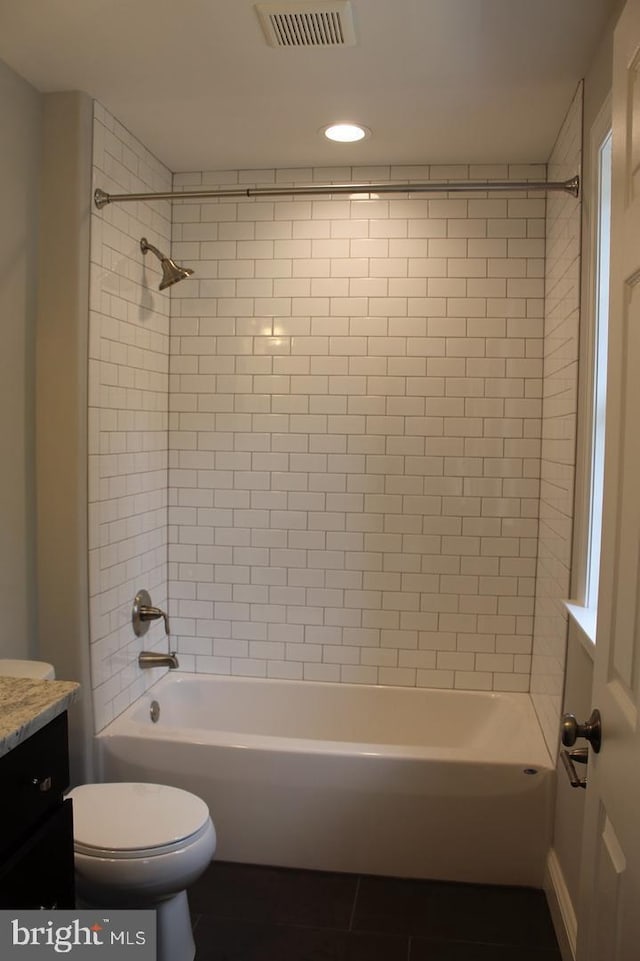 full bathroom with vanity, toilet, and tiled shower / bath combo