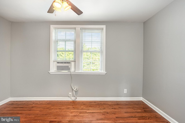 empty room featuring hardwood / wood-style flooring, a healthy amount of sunlight, ceiling fan, and cooling unit