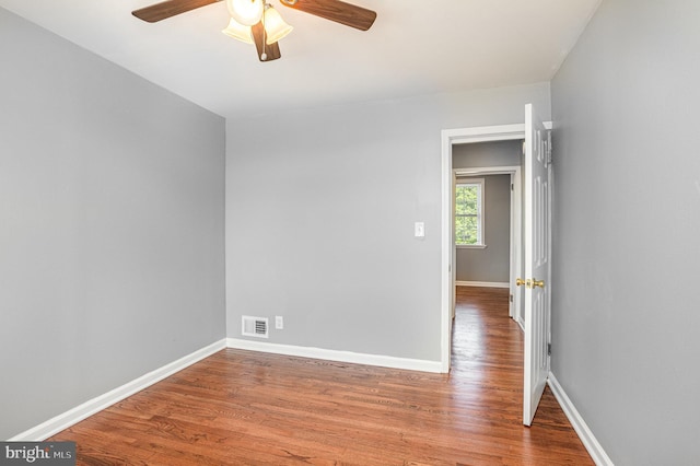 spare room featuring wood-type flooring and ceiling fan