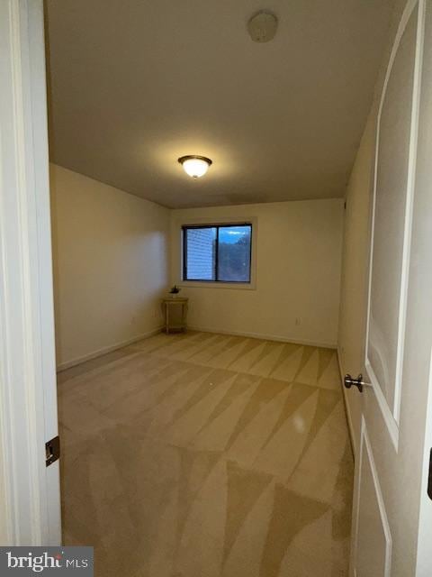 unfurnished room with light colored carpet