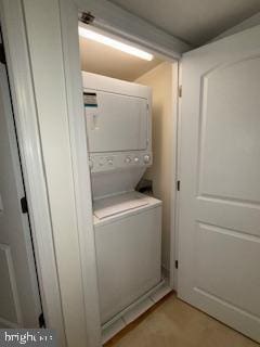 laundry room with stacked washer / dryer