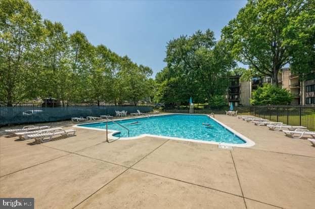 view of swimming pool with a patio area