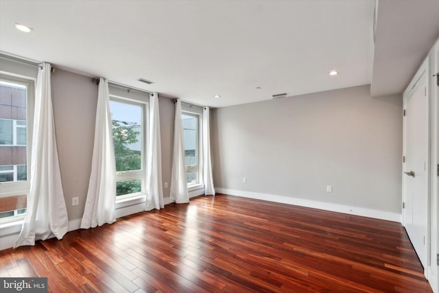 unfurnished room with hardwood / wood-style floors