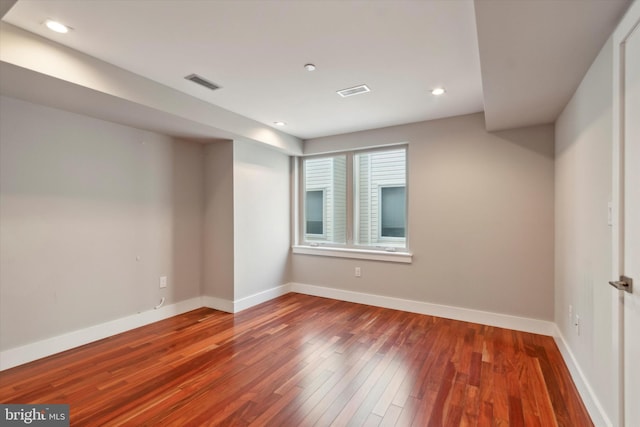 spare room with wood-type flooring