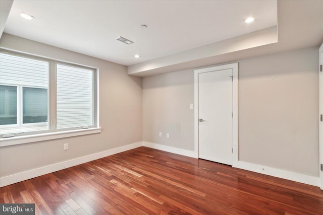 unfurnished room with hardwood / wood-style floors and a healthy amount of sunlight